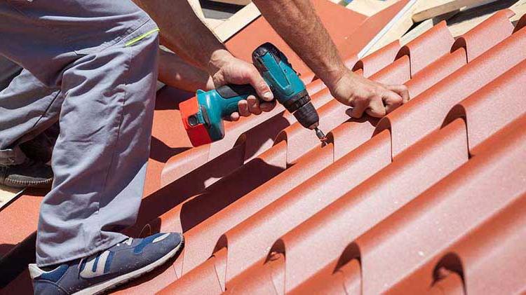 Man installing a metal roof.